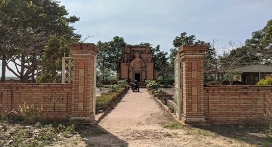 The surrounding fence built with orange-red bricks to match the site