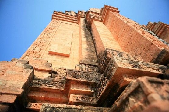 Ancient patterns on the tower columns still covered with moss